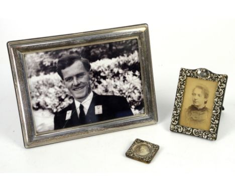 Three silver-mounted photograph frames including a Victorian frame with scrolling leaves, by Britton, Gould &amp; Co, Birming