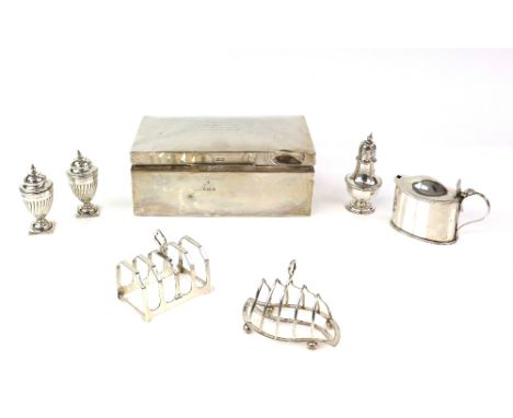 Group of silver items to include a George V cigarette box, Birmingham 1916, two toast racks, mustard pot, pair of pepperettes