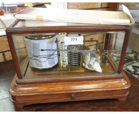 "A brass Barograph with ivory thermometer mounted upon oak stand with fitted drawer on shallow bracket feet within glazed cas