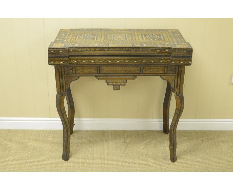 "A 19th Century Syrian Card Table with all over geometric design and mother of pearl inlay, shaped rectangular fold-over top 