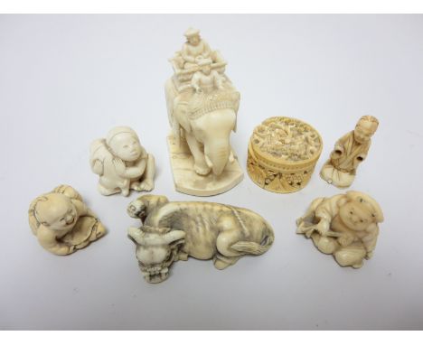 "A carved Ivory Netsuke in the form of reclining Ox with attendant, two others of children with turtle and monkey, an elephan