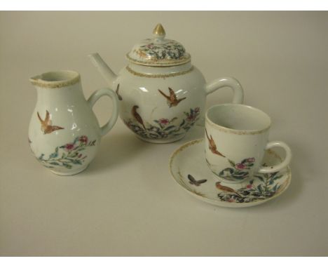 "An 18th Century Qianlong Teapot, Jug and matching Cup and Saucer, coloured enamel birds, butterflies and flowers "