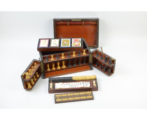 "A Victorian Coromandel Games Box with various compartments and fittings for dominoes, draughts, chess, crib, playing cards, 