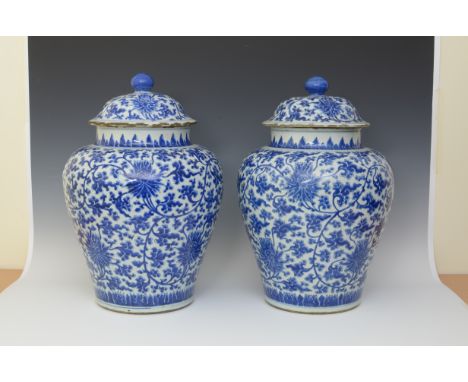 "A large pair of Chinese blue and white lidded Vase with lotus and scroll decoration, the lids with blue knobs, freize to nec