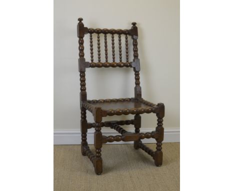 "A 17th Century oak Side Chair with bobbin turned frame, solid seat on turned and square front legs"