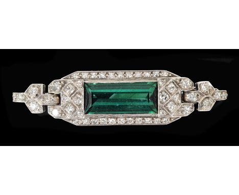 An Art Deco Tourmaline and Diamond Brooch millegrain-set step-cut green tourmaline within eight-cut diamonds converted from a