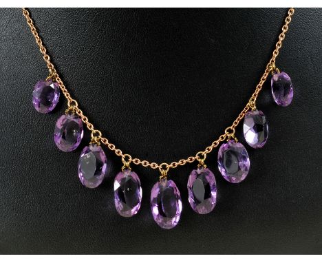 An Amethyst Fringe Necklace the front suspending  nine graduated oval-cut stones on fine chain stamped 9ct