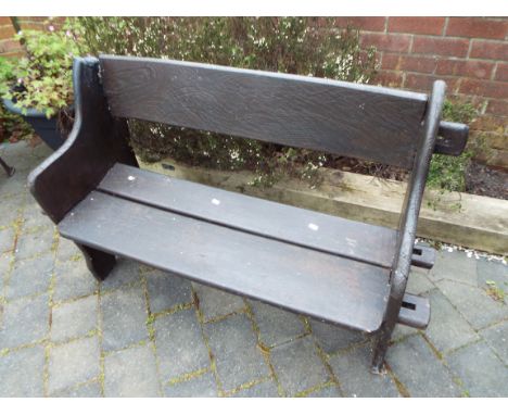 A garden bench seat with pegged plant sides and wide slatted seat and back, the whole painted brown, restoration to top left 