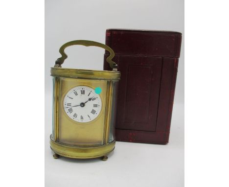 A late 19th/early 20th century French gilt metal carriage clock with leather fitted travel case. The white enamel dial having