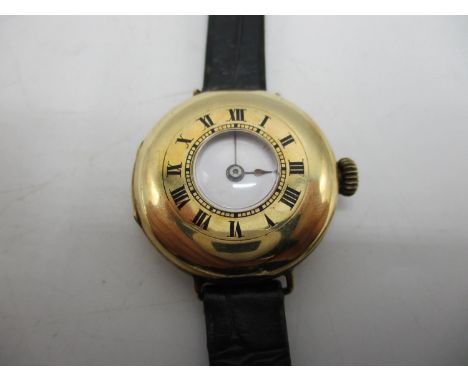 An early 20th century 9ct gold half hunter wire-lug wristwatch having a white enamel dial with Roman numerals, the case back 