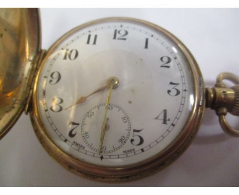 An early 20th century 9ct gold Full Hunter keyless wind pocket watch in a Dennison case.&nbsp; The white enamel dial having A