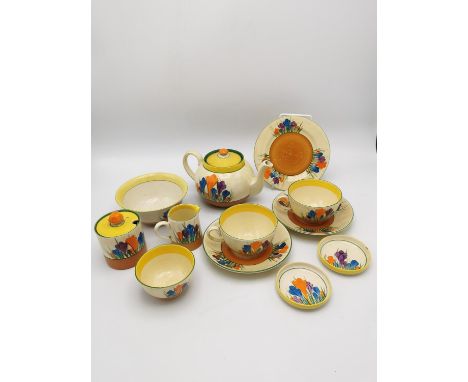 A Clarice Cliff Crocus pattern tea service, comprising a teapot, lidded sugar pot, milk jug, two tea cups and saucers, two sm