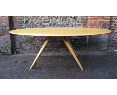 A Modern Design light oak dining table by Benchmark Furniture, of oblong form supported on four tapered splayed legs, with la