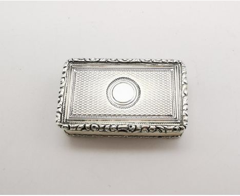 A William IV silver and silver gilt vinaigrette, London 1834, with engine turned decoration to the hinged lid, opening to rev