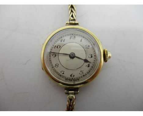 An early 20th century Longines 18ct gold ladies manual wind wristwatch on a 9ct gold strap. The dial having Arabic numerals, 