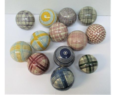 A group of thirteen Victorian Scottish ceramic carpet bowls, with colourful tartan and striped motifs 