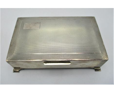 A Queen Elizabeth II silver cigarette box by Bert Gordon, Birmingham 1958, of rectangular form with engine turned detail to l