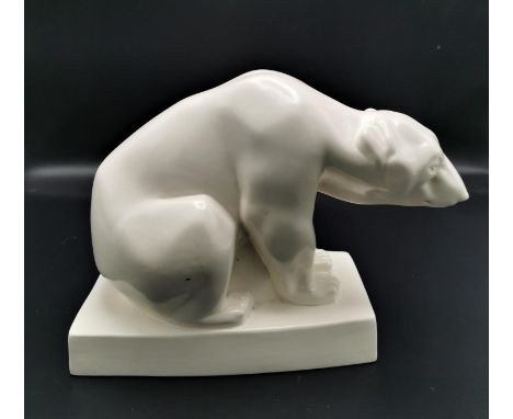 A 1920s Wedgwood cream glazed ceramic polar bear designed by John Skeaping, raised on a rectangular base, with marks to under