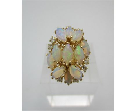 A 14ct gold, diamond and white opal cluster ring, inset with eleven almond shaped opals and eight small round brilliant cut d