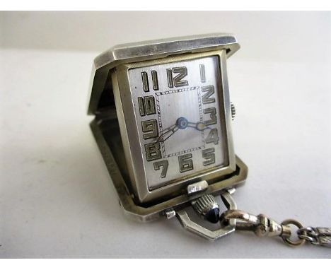 An Edison Watch Company silver travellers pocket watch with an engine turned, spring loaded, snap shut case and Arabic numera