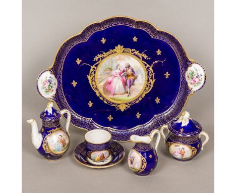 A 19th century Continental porcelain tea set
Comprising: a tray, teapot, sucrier, cup and saucer and cream jug, each piece pa