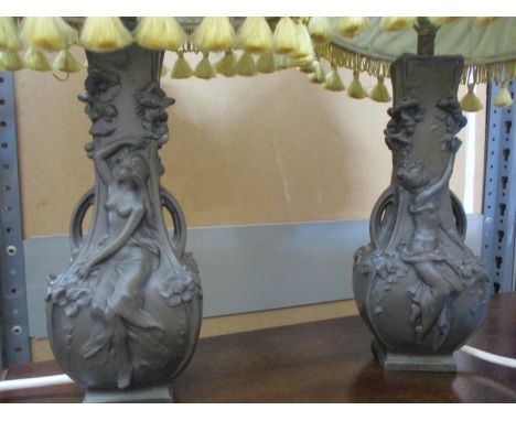 A pair of resin table lamps in the style of Art Nouveau twin handled pewter vases, (lamp shades A/F), signed 