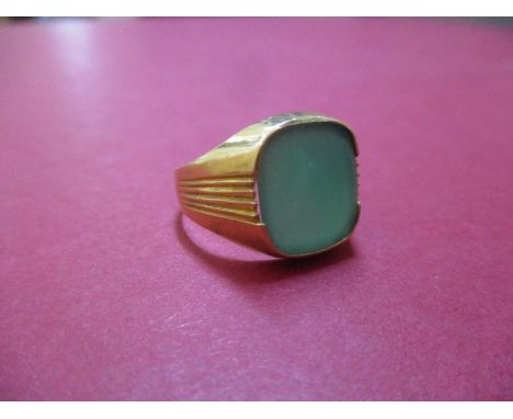 A 14ct gold gents signet ring set with a green stone, total weight 5.4g 