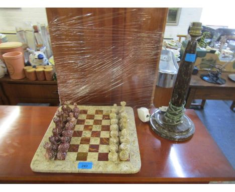 A granite and stone chess set and board, along with a Cornish serpentine turned table lamp 