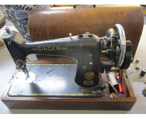 A 1940's Singer sewing machine in wooden case, serial no. EC647226 with accessories, together with an Acctim reproduction wal