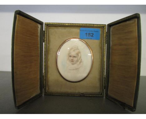 A miniature portrait of a young child highlighted in watercolour in a Debenham and Gould Bournemouth leather cased frame 