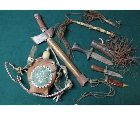 Collection of tribal items including wooden handled Kris in wood scabbard, knives, water bottle and fly swatters 