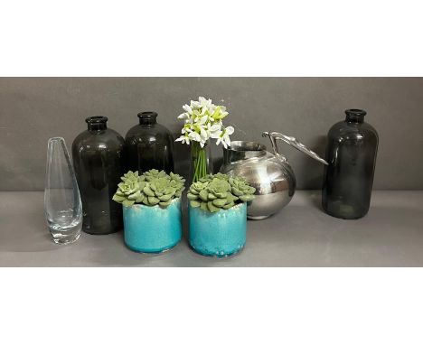 A selection of household decorative items to include glass bottles, an Art Deco style jug and faux plants 