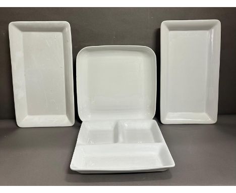 Four large white ceramic serving dishes 