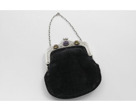 AN EDWARDIAN SCOTTISH MOUNTED BLACK VELVET EVENING BAG set with a faceted amethyst and two faceted citrine bosses and engrave