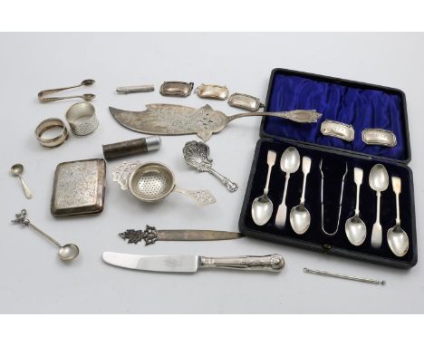 A MIXED LOT :- a cased set of 6 Fiddle pattern teaspoons and a pair of sugar tongs, a cigarette case, 5 wine labels, a tea st