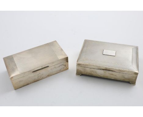 TWO ELIZABETH II RECTANGULAR CIGARETTE BOXES with engine-turned covers (one with bracket feet) and cedar wood linings; the la