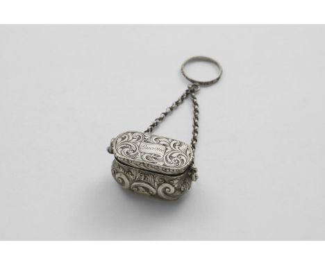 A VICTORIAN VINAIGRETTE in the form of a handbag, with chased and engraved decoration and a chain and finger-ring handle, the