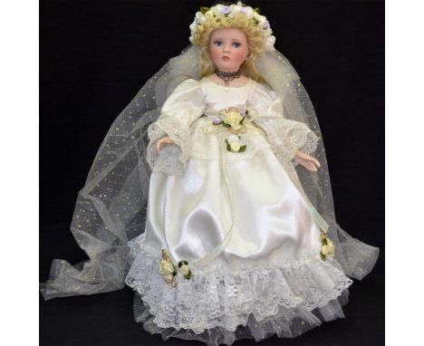 A Vintage, Unique, Bisque Porcelain Decorated Bride Doll dressed in a White Satin and Lace Bridal Dress. A beautifuly enhance