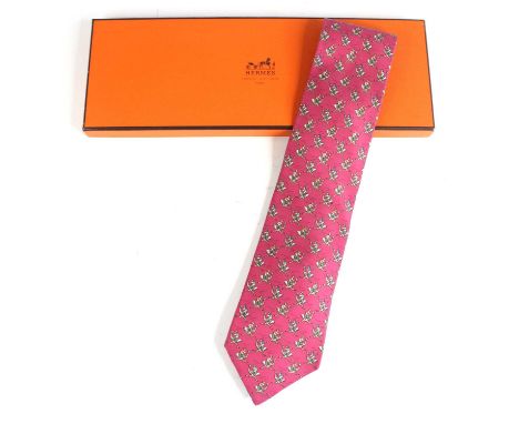 Hermès of Paris - a silk tie, pink colour with repeating figures of jockeys on ostriches, No.9787, housed in original card bo