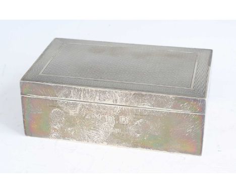 An Art Deco silver table cigarette box, having engine turned hinged cover enclosing cedar lined twin division interior, maker