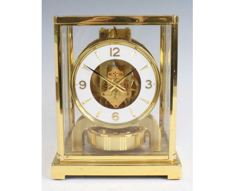 Jaeger Le Coultre - a gilt brass cased and glass panelled 'Atmos' clock, having a circular white backed chapter ring, stamped