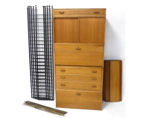 An extensive 1970s Ladderax teak four-bay modular wall unit, comprising a three drawer chest section, two fall-front sections