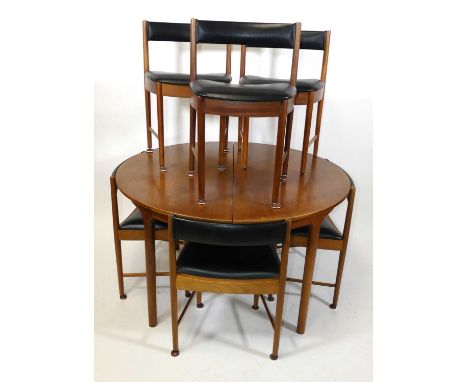 A 1960s teak dining suite by A.H. McIntosh, comprising; D-end extending dining table with pull-out action and single fold-out