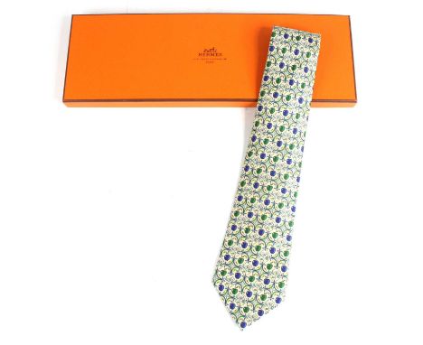 Hermès of Paris - a silk tie, the cream ground with repeating apples and floral lozenge design, No.7691, housed in original c