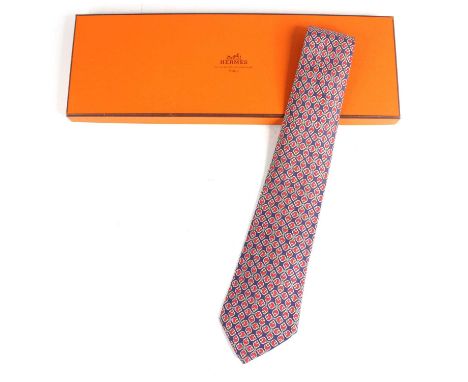 Hermès of Paris - a silk tie, the blue ground with red stylised four-leaf cross repeating design, No.7271, housed in original