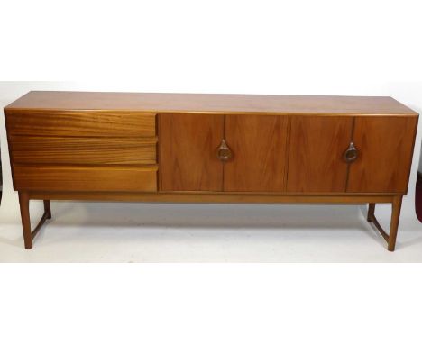 A 1960s teak long sideboard by A.H. McIntosh, having three long drawers, the upper drawer compartmentalised and baize-lined f