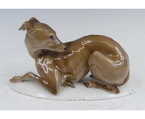 Professor Theodor Karner (1884-1966) for Rosenthal - a porcelain figure of a greyhound, in recumbent pose, raised on integral