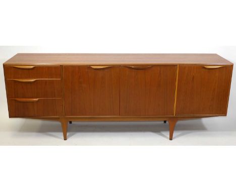 A 1960s teak long sideboard by A.H. McIntosh, having three end drawers, the upper drawer with compartmentalised and baize-lin