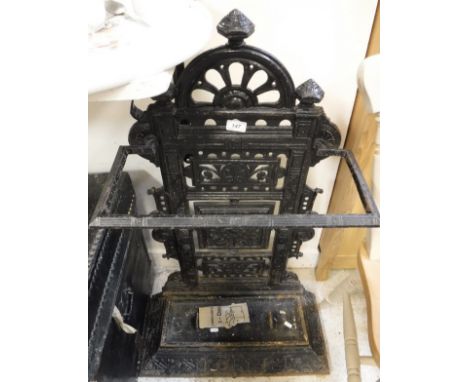 A cast iron stick stand with flower decoration