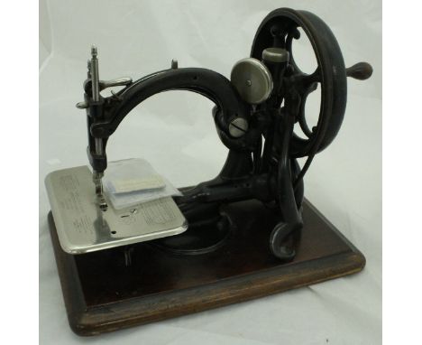 A circa 1880 Willcox & Gibbs chain stitch sewing machine with pack of spare grooved needles, the machine marked "Willcox & Gi